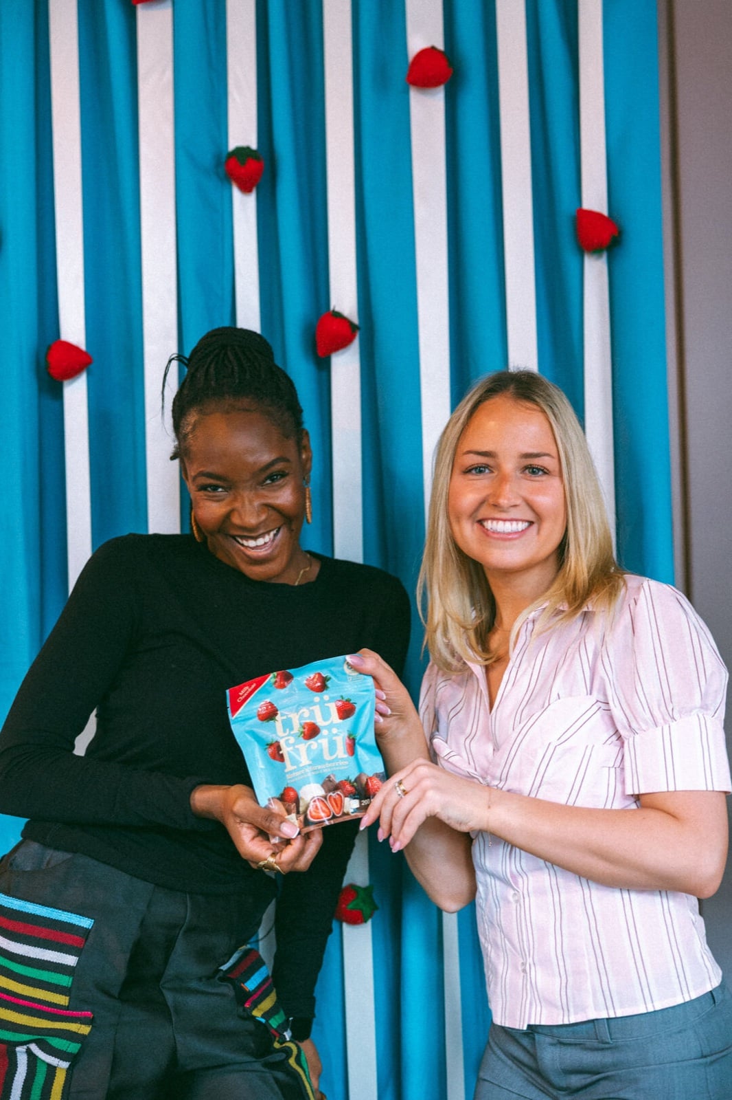Guests with Trü Frü product at the Galentines photo wall