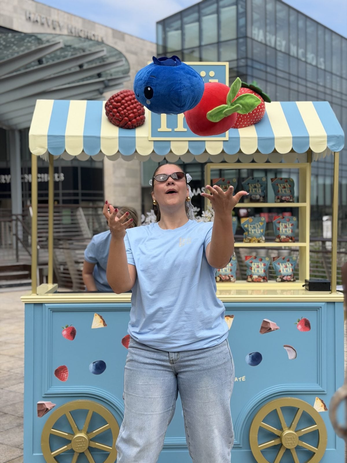 A Trü Frü team member juggling strawberries at the cart in Dundrum.