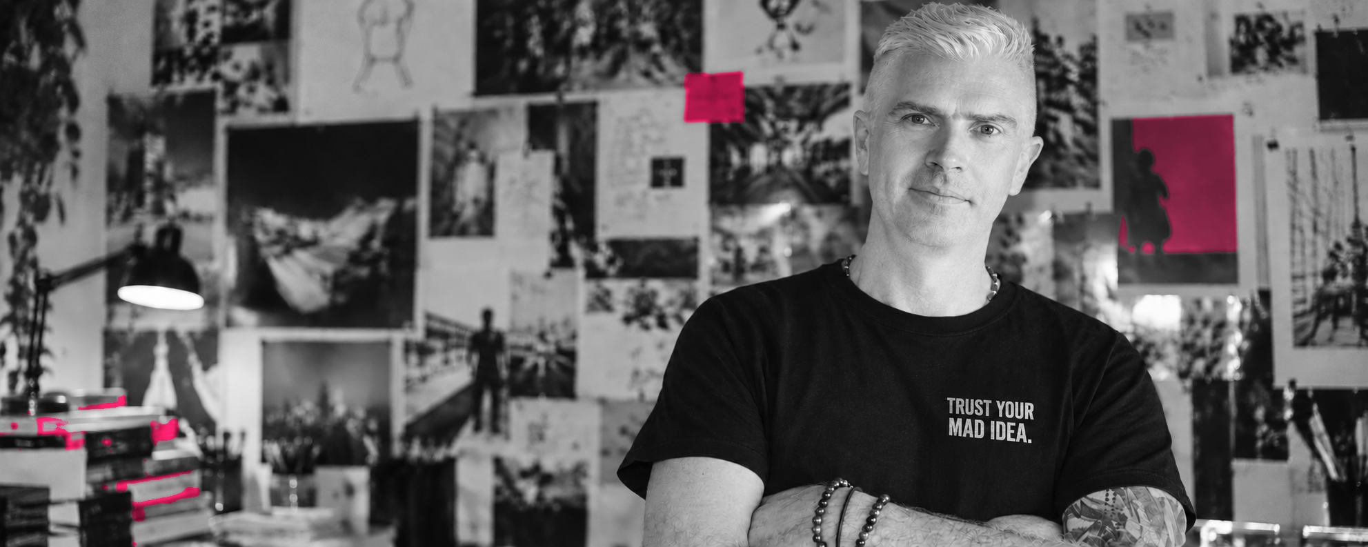Andrew Casey in the studio, wearing a Trust your mad idea T-shirt.