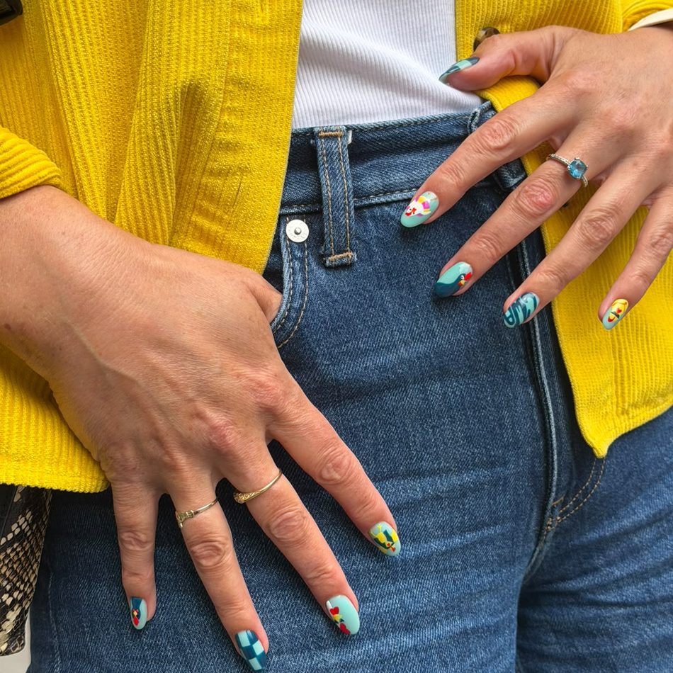 Chicken with Attitude nail art, two hands against denim and a yellow cardigan.